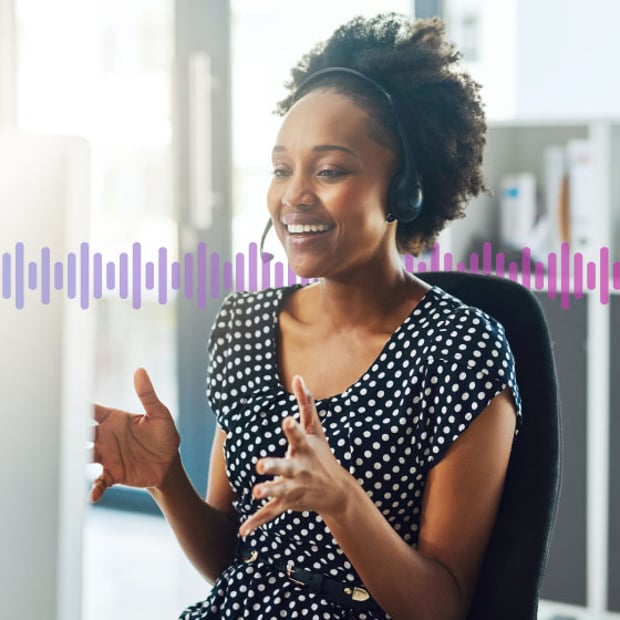 Photo of a smiling contact center agent talking to a customer through her phone headset. In the background, a series of small gradient purple lines run across the frame.