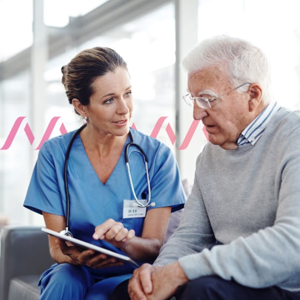 Photo-illustration of a brunette female doctor in blue scrubs seated with a stethoscope draped across her neck and a tablet in her hand, which is she showing to an elderly white-haired man who is her patient
